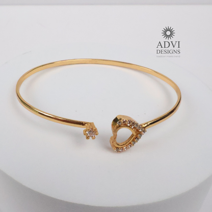 Gold-Tone Heart-Shaped Crystal Bangle with Double Heart Detail