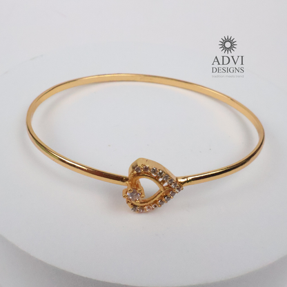 Gold-Tone Heart-Shaped Crystal Bangle with Double Heart Detail