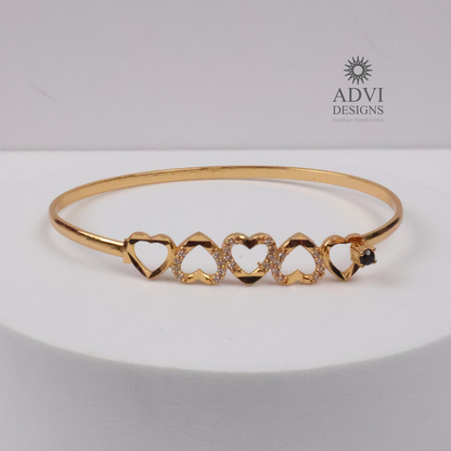 Gold-Tone Multi-Heart Bangle with Crystal Detailing & Black Stone Accent