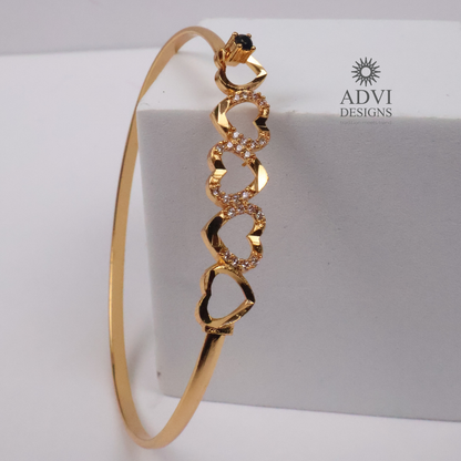 Gold-Tone Multi-Heart Bangle with Crystal Detailing & Black Stone Accent