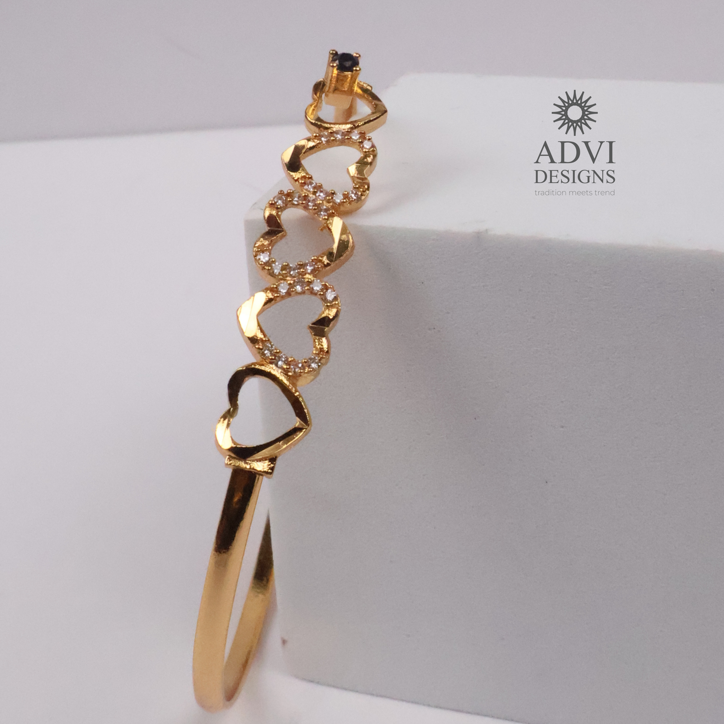 Gold-Tone Multi-Heart Bangle with Crystal Detailing & Black Stone Accent