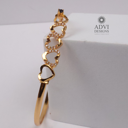 Gold-Tone Multi-Heart Bangle with Crystal Detailing & Black Stone Accent