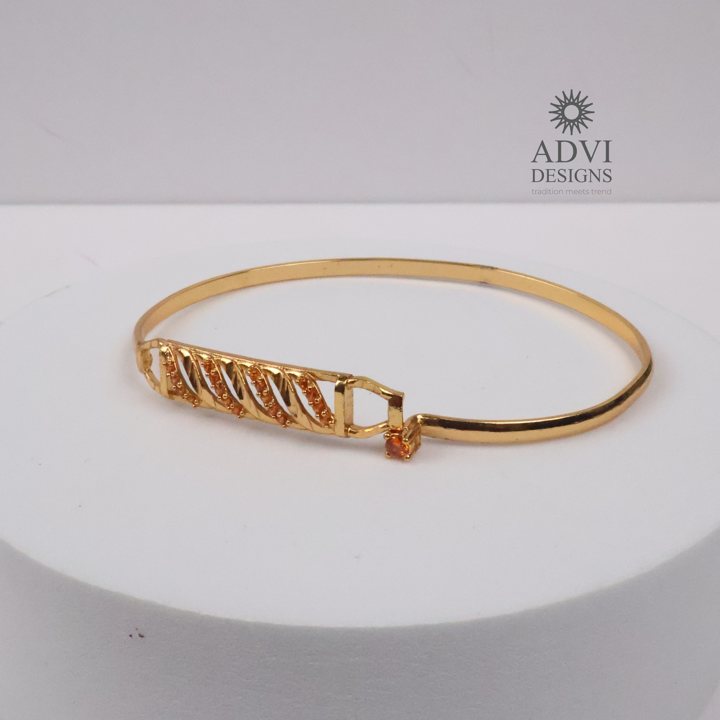 Gold-Tone Geometric Bangle with Diagonal Crystal Detailing & Orange Stone