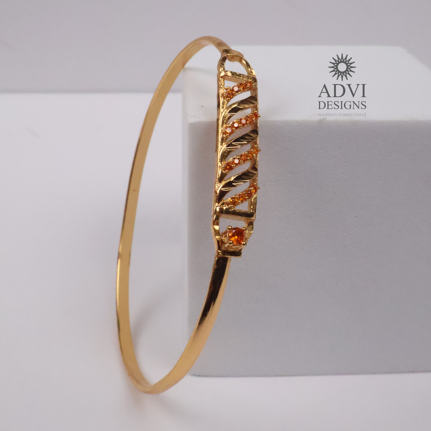 Gold-Tone Geometric Bangle with Diagonal Crystal Detailing & Orange Stone
